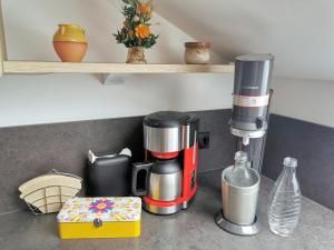a coffee maker on a counter in a kitchen at Ferienwohnung Schöne Auszeit in Markkleeberg +16 photos