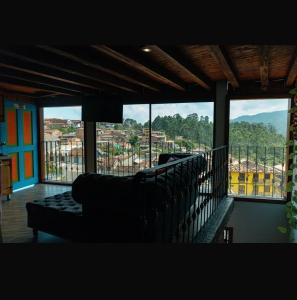 a living room with a couch and large windows at Suite Master in Jericó +6 photos