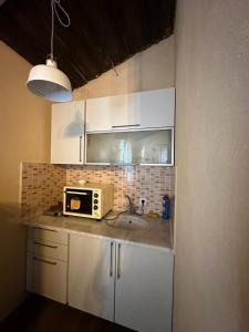 a kitchen with a sink and a microwave at ZBB Villa & Bungalow in Alanya +32 photos