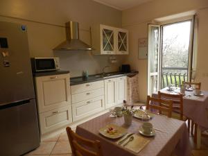 a kitchen with a table and a dining room at B&B Villa Maria in Terni
