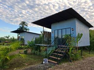 a small white house with a staircase leading to it at Arenal Tiny Lodge #1 in San Francisco +19 photos