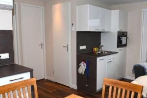 a small kitchen with a sink and a counter at Hausboot Dolce Vita in Klitten +7 photos