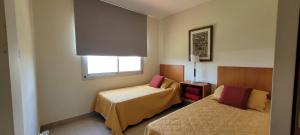 a room with two beds and a window at Casa de Miramar in Miramar