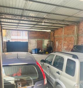 a garage with two cars parked in it at Hotel Carare Plaza in Cimitarra