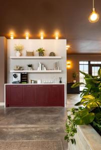 a kitchen with a red cabinet and white shelves at The Dylin in Madison +31 photos