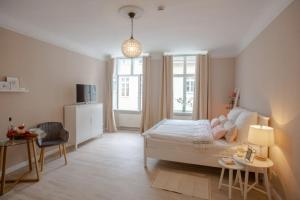 a bedroom with a bed and a table and a chair at Apartment No3 in Stralsund