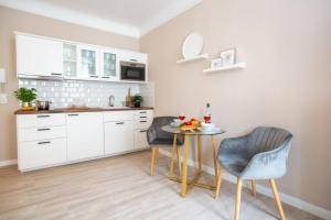 a kitchen with a small table and two chairs at Apartment No3 in Stralsund