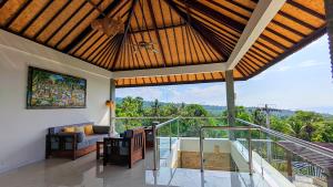 a living room with a balcony with a view at Luxurious, Seaview, Private Pool, 3-Bedroom Villa in Seraya in Seraya