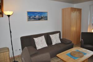 a living room with a couch and a coffee table at Ferienhaus Uferstraße in Wittmund