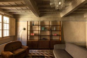 a living room with a couch and a book shelf at Numa Florence Palazzo San Niccolò in Florence