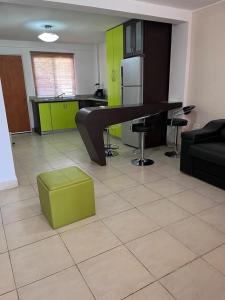 Habitación con mesa y cocina con armarios verdes. en Ciudad Flamingo, Morrocoy chichiriviche, tucacas 7, en Chichiriviche