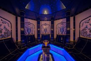 a jacuzzi tub in a room with blue lighting at Windeby 5D in Wenningstedt