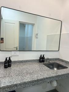 a bathroom counter with a mirror and a sink at Dpto CORRIENTES, Planta BAJA in Corrientes +14 photos
