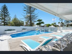 a group of chairs and a swimming pool at Endless ocean views, spacious, resort facilities in Gold Coast +29 photos