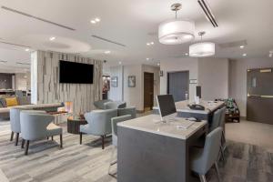 a lobby with chairs and a desk with a computer at Executive Residency by Best Western Toronto-Mississauga in Mississauga