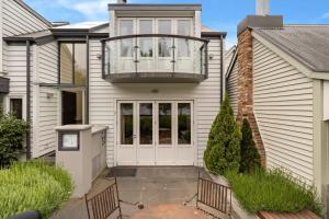 a house with a porch with a balcony at Glen Nevis 2- Queenstown Lakeshore Apt in Queenstown
