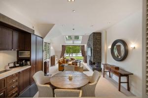 a kitchen and living room with a table and chairs at Creighton 1 Lake & Mountain View Apt in Queenstown