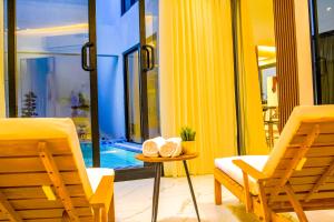 a room with two chairs and a table and a pool at The Land Resort in Riyadh +261 photos