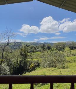 a view of a field from a window at Cabañas venado 2 in Venado +6 photos