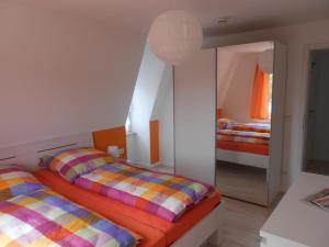 a bedroom with two beds and a mirror at Ferienwohnung Haus Glückauf in Kölpinsee