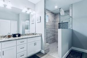 a white bathroom with a shower and a sink at Spectacular NEW Home With Lots of parking Exit 284 in Palm Coast +36 photos