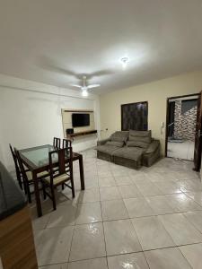 a living room with a couch and a table at Beach House Cabo Frio Hostel in Cabo Frio