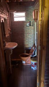 a small bathroom with a toilet and a sink at Sítio das pedras in Ijuí +51 photos
