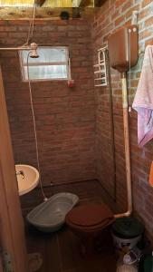 a small bathroom with a toilet and a sink at Sítio das pedras in Ijuí