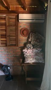 a small room with a bed in a brick wall at Sítio das pedras in Ijuí