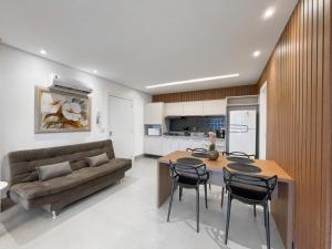 a living room with a couch and a table and chairs at Luxury Collection - The Journey in Campo Grande