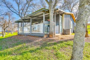a small house in a park with a tree at Fish, Hike & Relax: Rural Red Bluff Cottage in Red Bluff +18 photos