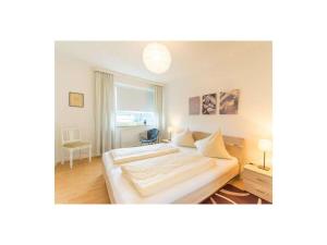 a bedroom with two beds and a large window at Perennial in the aft deck Comfortable holiday residence in Travemünde