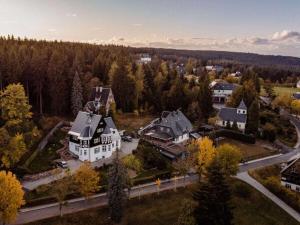 an aerial view of a large house in a residential neighborhood at Look into the country Comfortable holiday residence in Kurort Bärenburg
