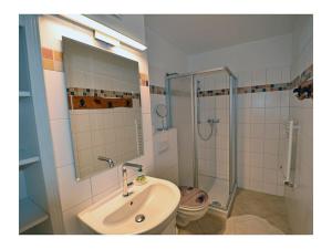 a bathroom with a sink and a shower at Beach Dune Comfortable holiday residence in Juliusruh
