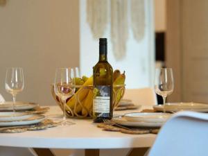 a bottle of wine sitting on a table with glasses at Cozy apartment near Mosel - top location - mountain view in Traben-Trarbach