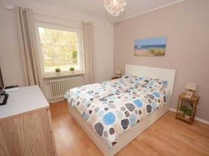 a bedroom with a bed and a window at Summer house by the sea Comfortable holiday residence in Sierksdorf