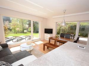 a living room with a couch and a table at Summer house by the sea Comfortable holiday residence in Sierksdorf