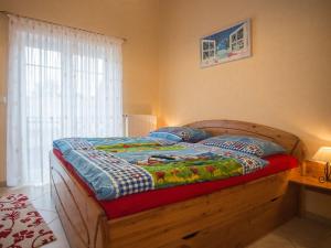 a bedroom with a wooden bed with a window at Haus Edelweiss Comfortable holiday residence in Winterberg