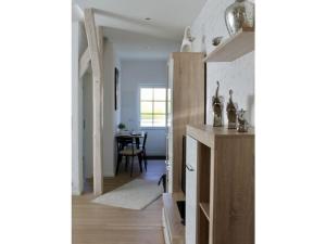 a kitchen with wooden cabinets and a dining room at Holiday home with style Holiday apartment Rosenstraße links in Grömitz +13 photos