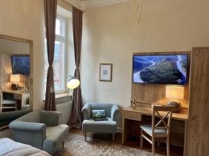 a room with a desk and a chair and a desk with a computer at Stadtvilla Laux Comfortable holiday residence in Merzig