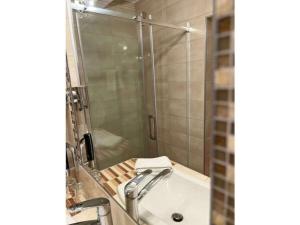 a bathroom with a shower and a sink and a tub at Stadtvilla Laux Comfortable holiday residence in Merzig +13 photos
