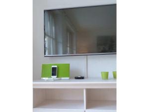 ein Regal mit zwei grünen Tassen und einem Spiegel in der Unterkunft Bergwiese Comfortable holiday residence in Oberstaufen