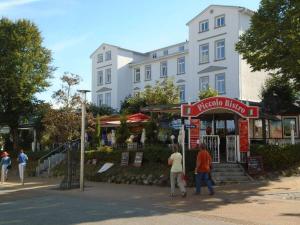 a group of people walking in front of a building at Koehler 2 Buskam 23 in Göhren