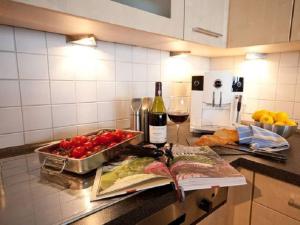 a kitchen counter with a book and a bottle of wine at Sea View No 19 Comfortable holiday residence in Wittdün +12 photos