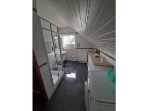 a bathroom with a tub and a sink and a mirror at Upper deck Comfortable holiday residence in Lindau +29 photos
