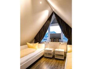 a living room with a couch and a window at Dream Penthouse 1 Comfortable holiday residence in Norddeich