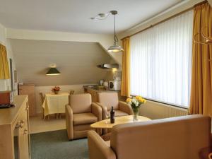 a living room with a table and a kitchen at Beach house F994 Comfortable holiday residence in Fehmarn