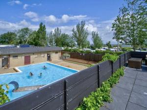 a swimming pool with two people in it at Holiday apartment F995 at Wulfener Hals, Fehmarn in Wulfen auf Fehmarn