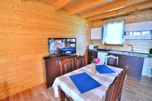 a dining room with a table and a television in a kitchen at Cottage in Jaros awiec near Seaside Beach in Jarosławiec