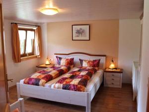 a bedroom with a large bed with two night stands at on the Willmann farm in Erlenbach